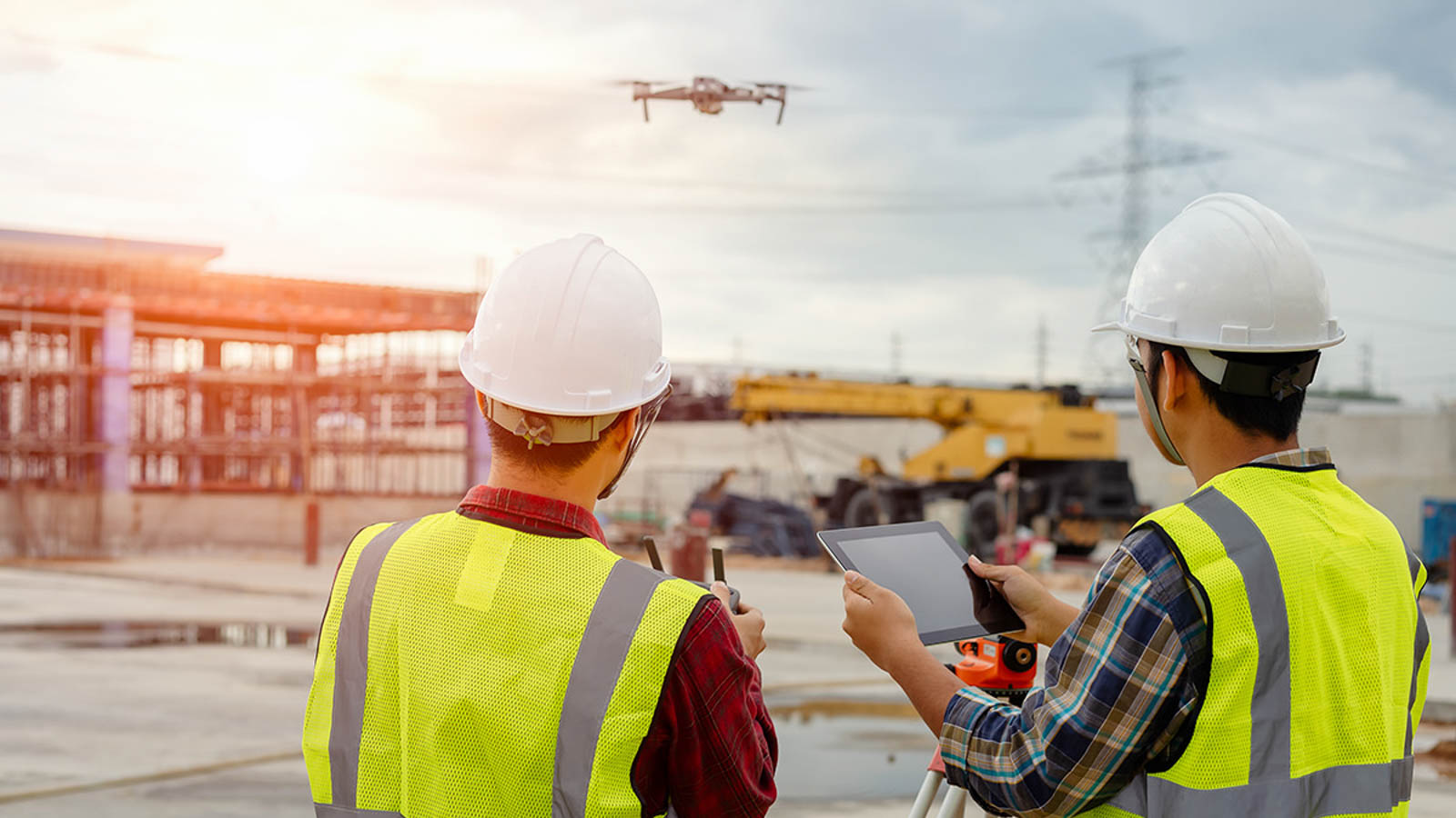 Drone operated by construction worker on building site,flying wi