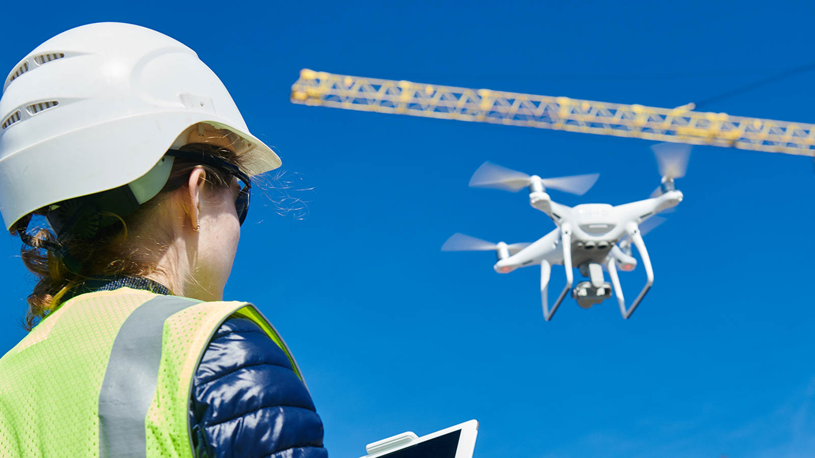 Drone inspection. Operator inspecting construction building site