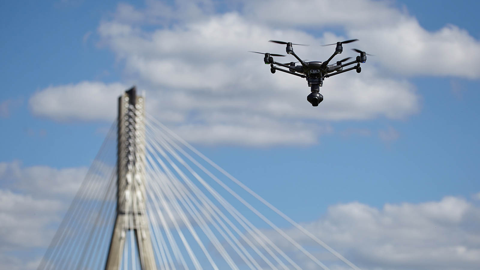Copter flight against the blue sky. RC aerial drone.